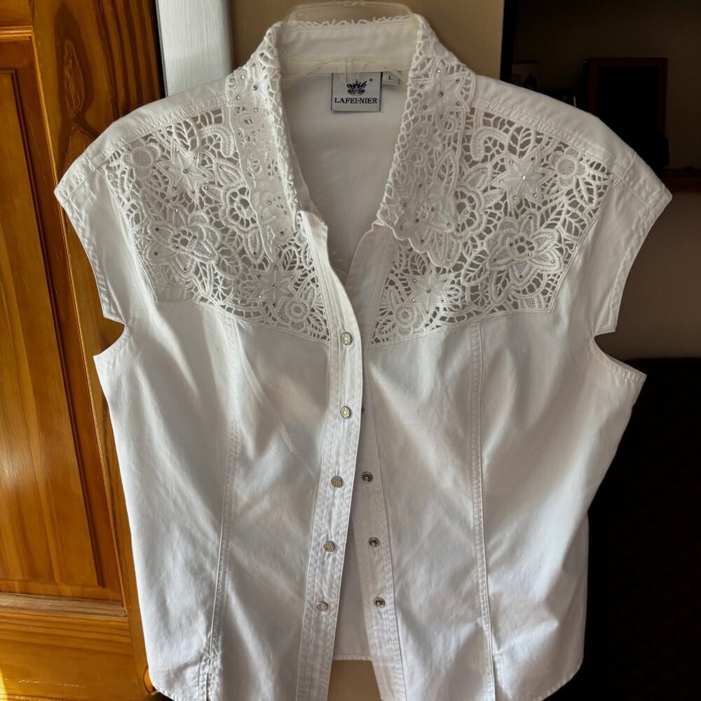 White, sleeveless, denim, western top with scalloped collar, floral cutouts.